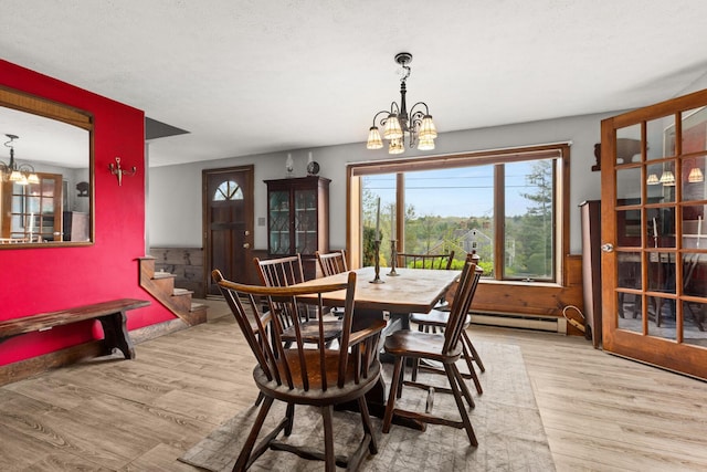 28 Ridgewood Dr, Eliot, ME 03903 - dining area with a chandelier, a baseboard radiator, and wood finished floors