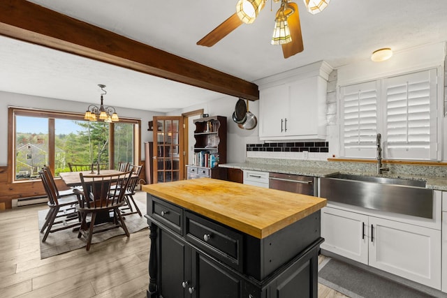 28 Ridgewood Dr, Eliot, ME 03903 - kitchen with butcher block counters, white cabinets, dark cabinets, a sink, and beamed ceiling