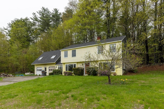 28 Ridgewood Dr, Eliot, ME 03903 - colonial home featuring an attached garage, asphalt driveway, a front yard, and a chimney