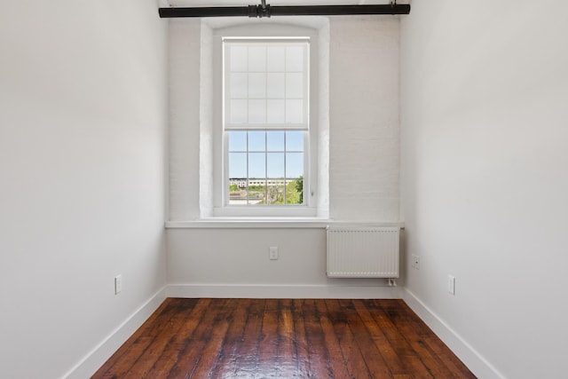 2 Main St Unit 17-410, Biddeford, ME 04005 - unfurnished room with radiator, dark wood-style floors, and baseboards