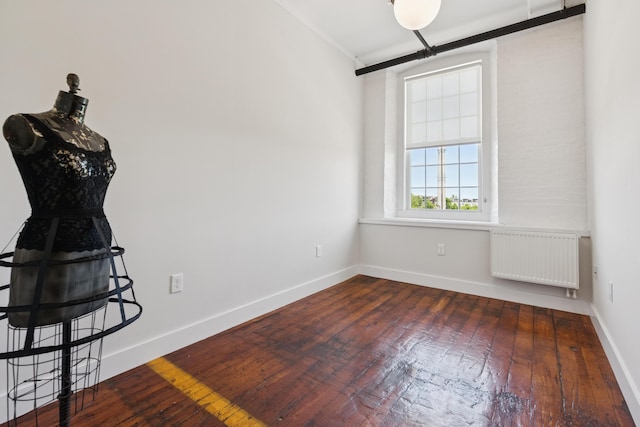 2 Main St Unit 17-410, Biddeford, ME 04005 - empty room with radiator heating unit, wood-type flooring, and baseboards
