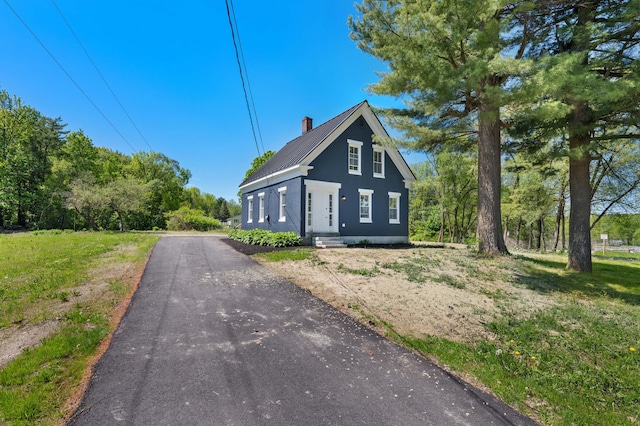 558 High St, West Gardiner, ME 04345 - view of property exterior with a chimney