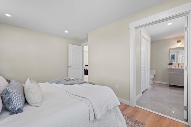 558 High St, West Gardiner, ME 04345 - bedroom with light wood-style flooring, connected bathroom, recessed lighting, baseboards, and a sink
