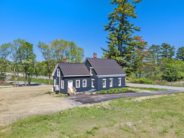 558 High St, West Gardiner, ME 04345 - view of side of property with a chimney, entry steps, metal roof, and driveway