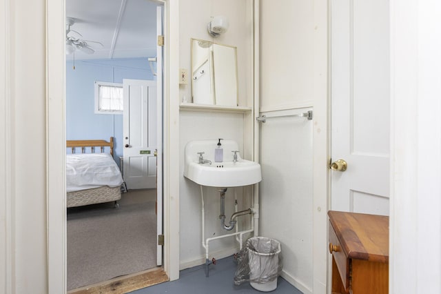 bathroom with baseboards, a sink, and ensuite bathroom