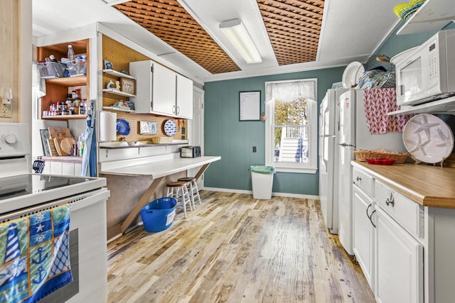 kitchen featuring white appliances, open shelves, light wood-style flooring, white cabinets, and light countertops
