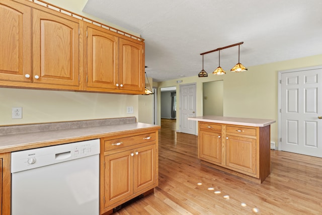 kitchen featuring dishwasher, light countertops, light wood-type flooring, and pendant lighting