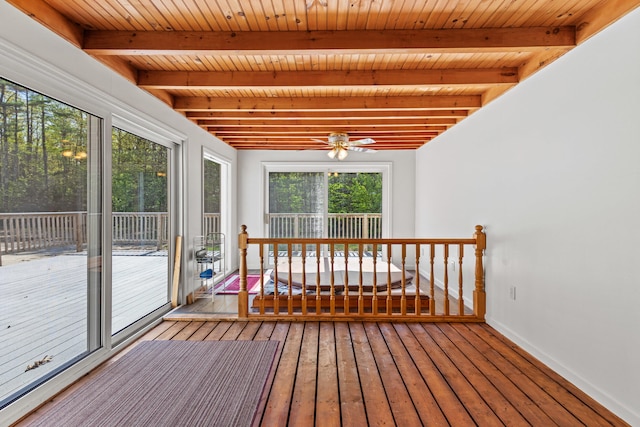 sunroom / solarium featuring beamed ceiling