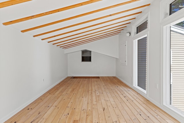 bonus room with wood-type flooring and baseboards