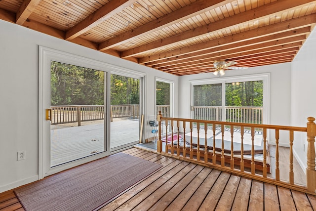 unfurnished sunroom featuring beam ceiling