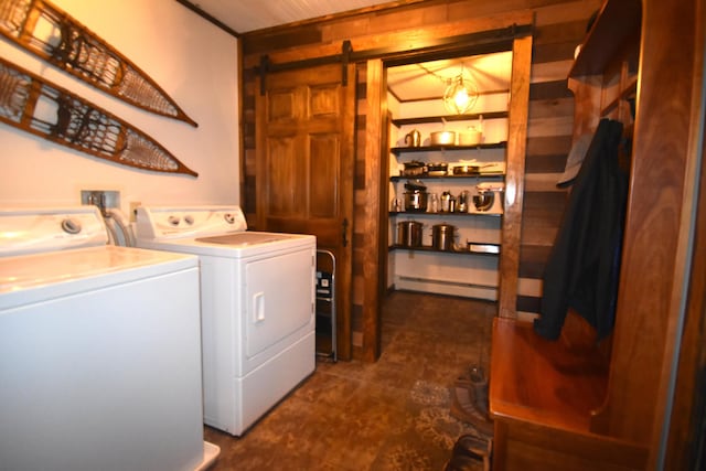 laundry room featuring a barn door, washing machine and clothes dryer, and baseboard heating