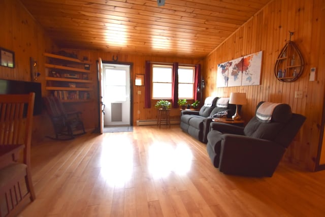 living room with wooden walls, a baseboard heating unit, lofted ceiling, wood finished floors, and wooden ceiling