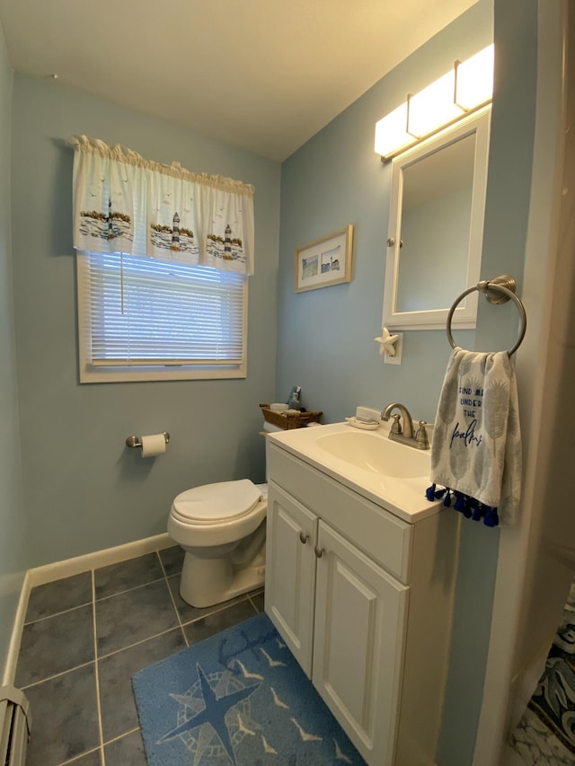 17 Canterbury Rd, Brewer, ME 04412 - half bath featuring a baseboard radiator, tile patterned floors, vanity, toilet, and baseboards