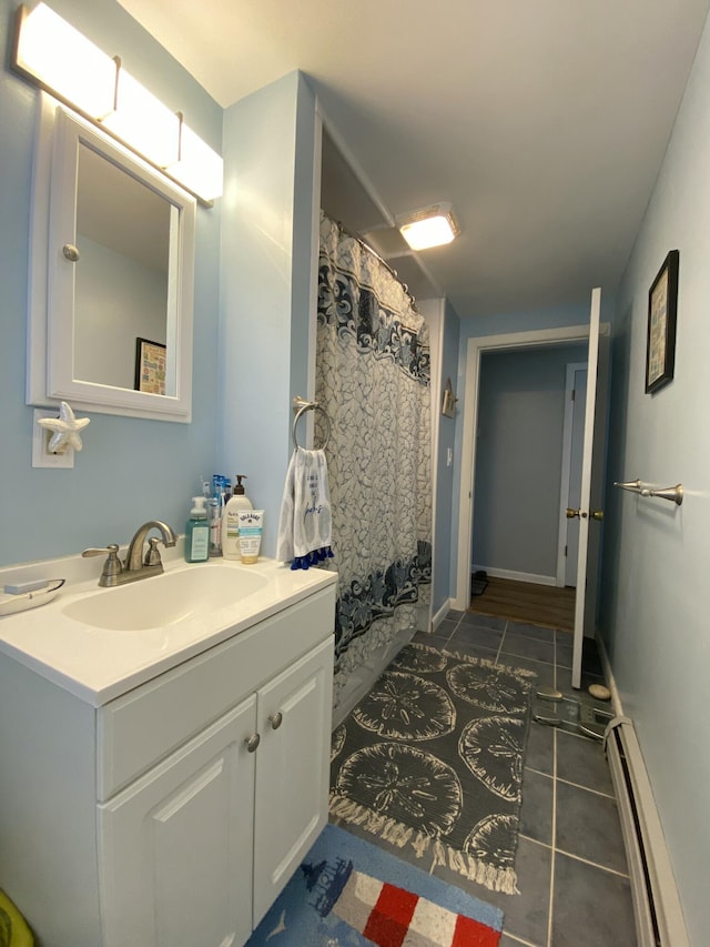 17 Canterbury Rd, Brewer, ME 04412 - bathroom with a baseboard heating unit, tile patterned flooring, vanity, and a shower with curtain