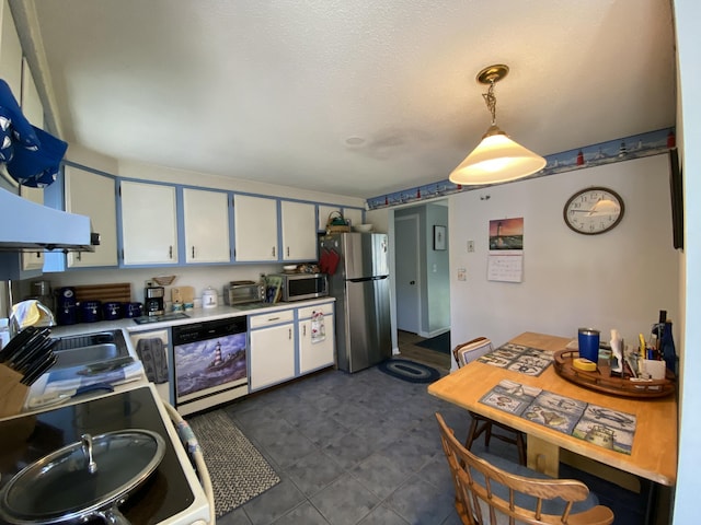 17 Canterbury Rd, Brewer, ME 04412 - kitchen featuring stainless steel appliances, light countertops, white cabinets, a sink, and pendant lighting