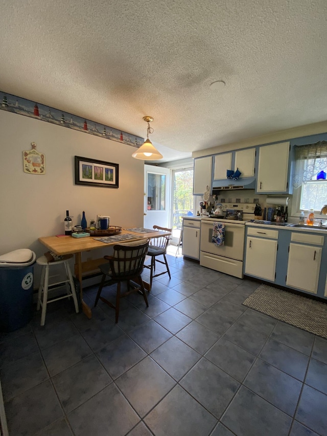 17 Canterbury Rd, Brewer, ME 04412 - dining area with plenty of natural light, dark tile patterned flooring, and a textured ceiling