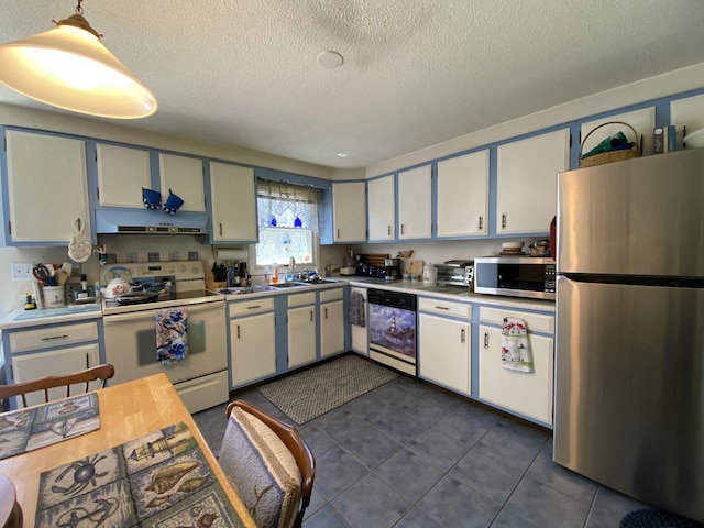 17 Canterbury Rd, Brewer, ME 04412 - kitchen featuring appliances with stainless steel finishes, a sink, a textured ceiling, dark tile patterned flooring, and light countertops
