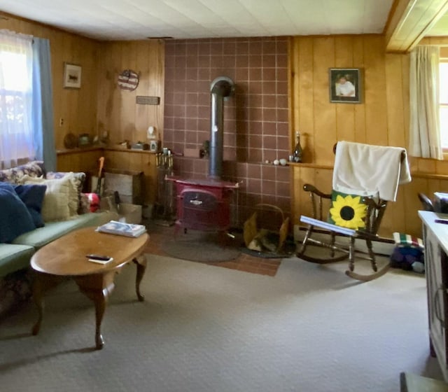 17 Canterbury Rd, Brewer, ME 04412 - living area featuring a wood stove, plenty of natural light, carpet, and wooden walls