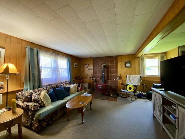 17 Canterbury Rd, Brewer, ME 04412 - living area with a wood stove, plenty of natural light, wooden walls, and carpet