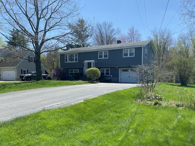 17 Canterbury Rd, Brewer, ME 04412 - split foyer home featuring a chimney, driveway, an attached garage, and a front lawn