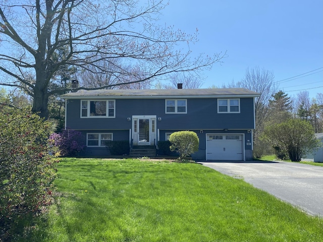 17 Canterbury Rd, Brewer, ME 04412 - raised ranch with driveway, a garage, a front yard, and a chimney