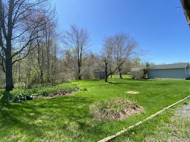 17 Canterbury Rd, Brewer, ME 04412 - view of grassy yard with a storage shed and an outbuilding