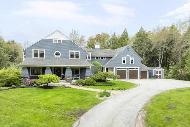 9 Edes Rd, Cumberland, ME 04021 - shingle-style home with a porch, a front lawn, asphalt driveway, an outdoor structure, and a chimney