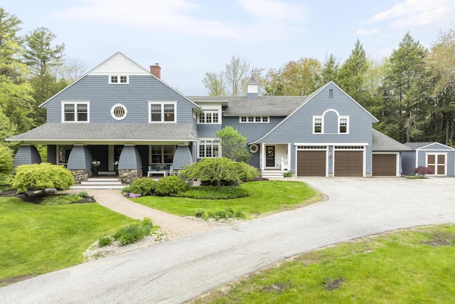 9 Edes Rd, Cumberland, ME 04021 - shingle-style home with a front yard, covered porch, asphalt driveway, a chimney, and roof with shingles