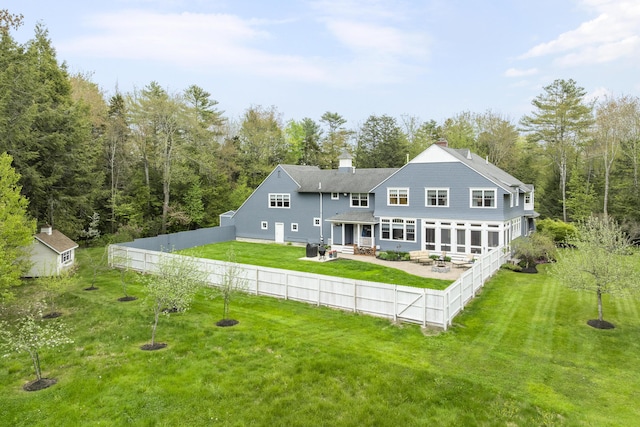 9 Edes Rd, Cumberland, ME 04021 - back of house featuring a patio, a chimney, and a forest view