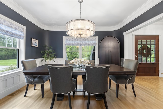 9 Edes Rd, Cumberland, ME 04021 - dining room featuring a chandelier, light wood-style flooring, ornamental molding, healthy amount of natural light, and a decorative wall