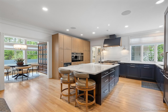 9 Edes Rd, Cumberland, ME 04021 - kitchen with crown molding, custom exhaust hood, light countertops, oven, and a kitchen island with sink