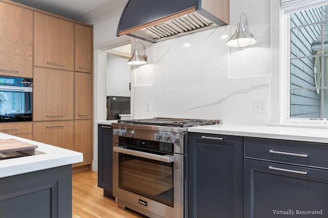 9 Edes Rd, Cumberland, ME 04021 - kitchen with high end stainless steel range oven, wall oven, premium range hood, light wood-style floors, and light stone counters