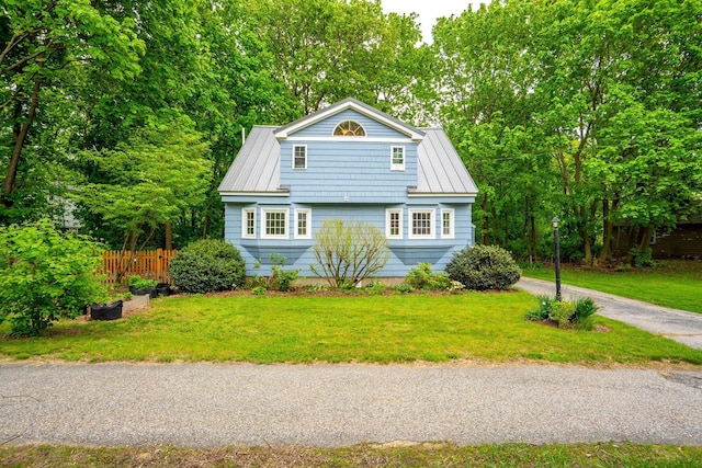 99 Spring St, Saco, ME 04072 - view of front of home featuring metal roof, a standing seam roof, and driveway