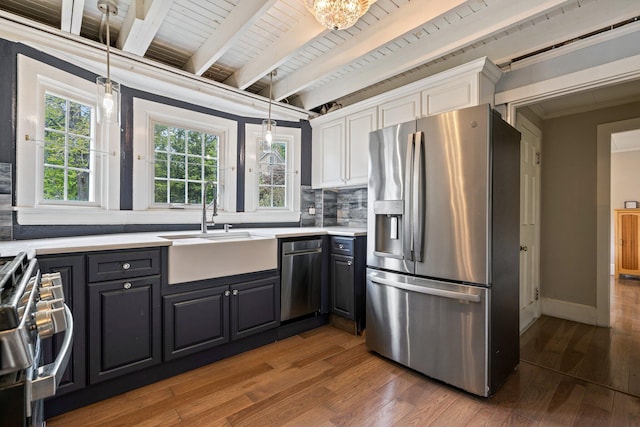 99 Spring St, Saco, ME 04072 - kitchen with stainless steel appliances, a sink, white cabinetry, hardwood / wood-style flooring, and crown molding