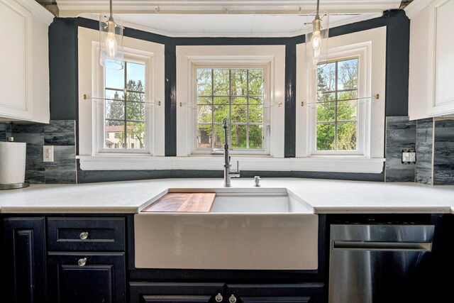 99 Spring St, Saco, ME 04072 - kitchen with a sink, dark cabinetry, stainless steel dishwasher, plenty of natural light, and crown molding