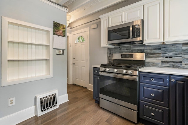 99 Spring St, Saco, ME 04072 - kitchen featuring stainless steel appliances, blue cabinetry, backsplash, baseboards, and dark wood-style floors