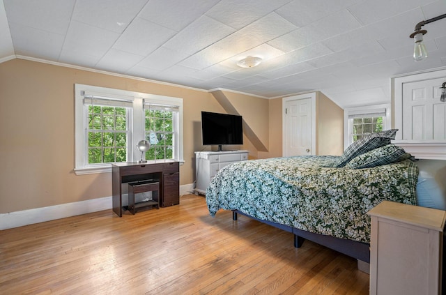 99 Spring St, Saco, ME 04072 - bedroom with crown molding, multiple windows, light wood-type flooring, baseboards, and vaulted ceiling