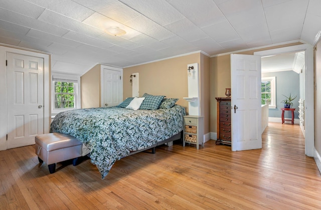 99 Spring St, Saco, ME 04072 - bedroom featuring light wood-style floors, ornamental molding, multiple windows, and baseboards