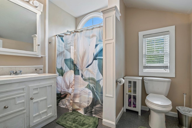 99 Spring St, Saco, ME 04072 - bathroom featuring toilet, vanity, lofted ceiling, a shower with curtain, and baseboards