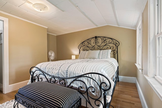 99 Spring St, Saco, ME 04072 - bedroom with wood finished floors, baseboards, crown molding, and vaulted ceiling