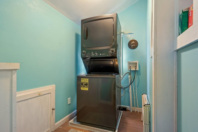 99 Spring St, Saco, ME 04072 - laundry area featuring estacked washer and dryer, hardwood / wood-style floors, and baseboards