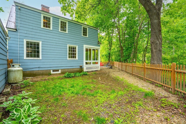 99 Spring St, Saco, ME 04072 - back of house featuring a chimney and a fenced backyard