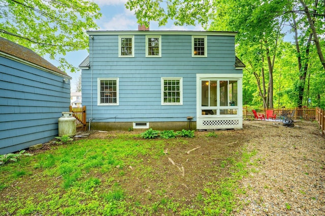 99 Spring St, Saco, ME 04072 - rear view of property with a chimney, a fenced backyard, and a sunroom