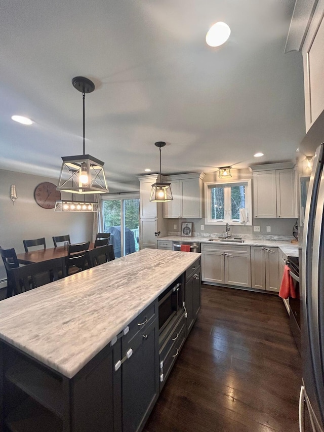 284 Roosevelt Trl, Windham, ME 04062 - kitchen featuring a sink, light countertops, appliances with stainless steel finishes, dark wood-style floors, and a kitchen island