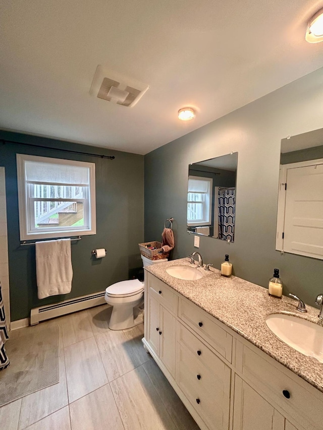 284 Roosevelt Trl, Windham, ME 04062 - full bath featuring a baseboard heating unit, double vanity, and toilet