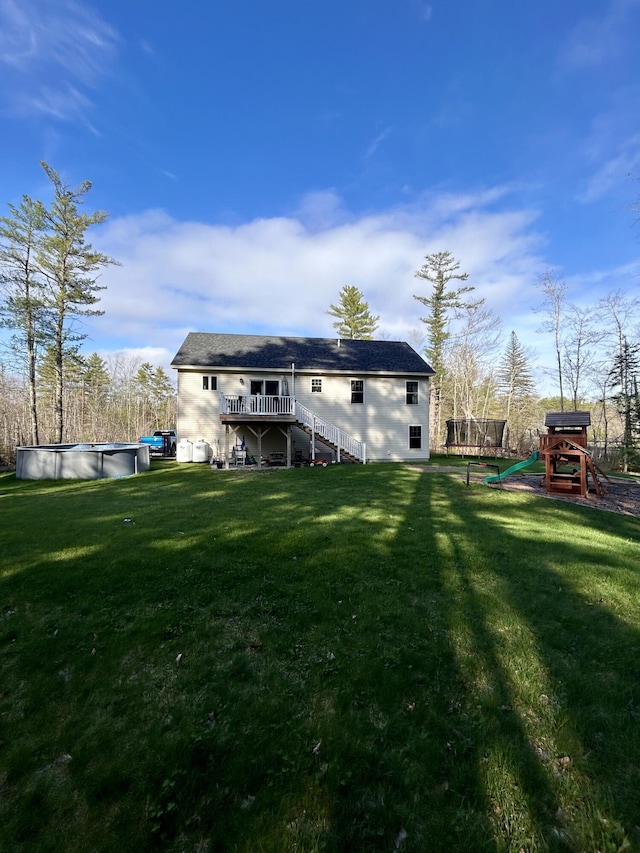 284 Roosevelt Trl, Windham, ME 04062 - back of property with stairs, a deck, a covered pool, and a lawn