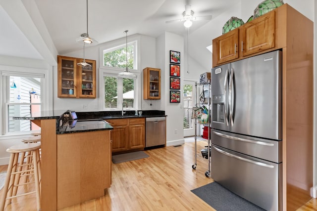 23 Amerescoggin Rd, Falmouth, ME 04105 - kitchen featuring appliances with stainless steel finishes, a breakfast bar area, a sink, light wood finished floors, and high vaulted ceiling