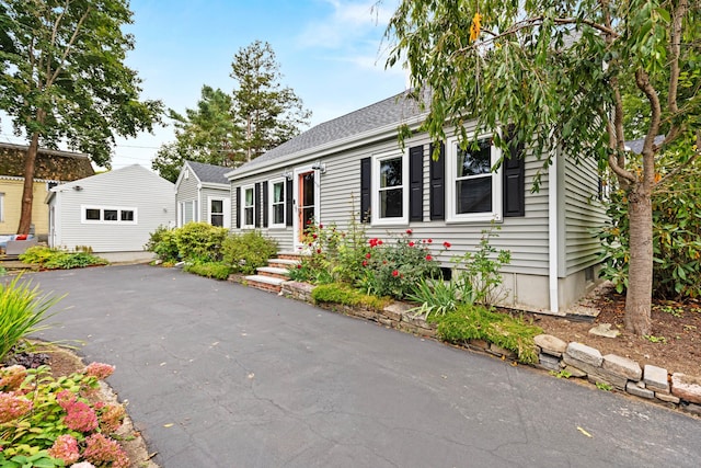 23 Amerescoggin Rd, Falmouth, ME 04105 - view of front of home with an outbuilding and roof with shingles
