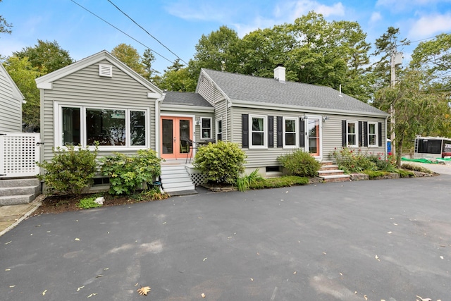 23 Amerescoggin Rd, Falmouth, ME 04105 - view of front of property with a chimney, french doors, and roof with shingles