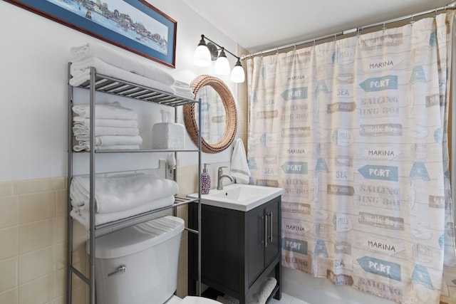 23 Amerescoggin Rd, Falmouth, ME 04105 - full bath featuring tile walls, vanity, toilet, curtained shower, and a wainscoted wall